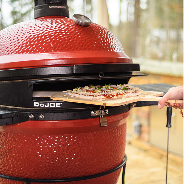 A pizza being fed into the DõJoe using the pizza peel