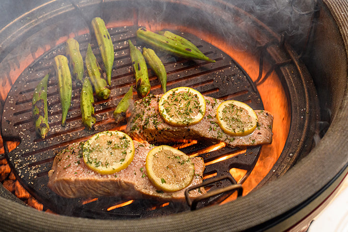 Salmon and okra being cooked to perfection on the Kamado Joe® Sear Plate