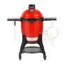 A red Classic Joe III grill with black side shelves, Kontrol Tower top vent, and heavy-duty cart with wheels. A temperature gauge is built into the grill dome. A sliding steel access door is built into the bottom of the grill base. Ash scraper and accessory rack hang from the side shelves