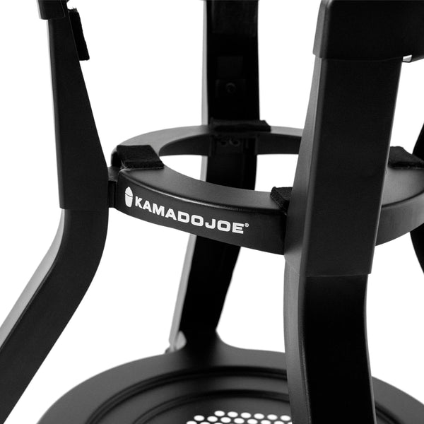 Closeup of the round support in the cart where the grill base sites. The support is mounted between the cart legs, which curve in to fit the support, then flare out again below the support.  The support has pads on it to protect the grill base.