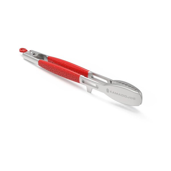 Stainless steel tongs with dimpled red handles sitting on the edge notch sop the head is raised from the surface.