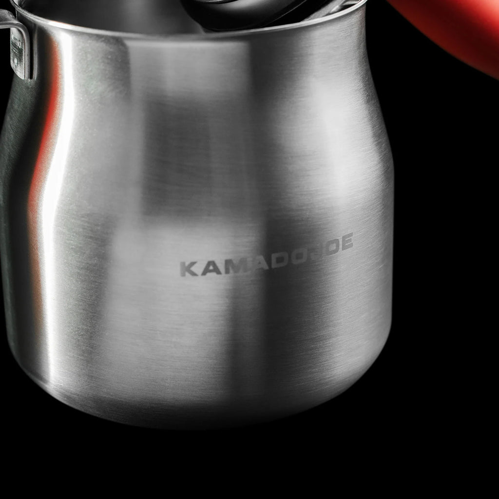 Closeup of the steel basting pot with the words Kamado Joe etched on it