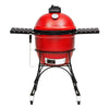 Red Classic Joe I Kamado grill with 2 black side shelves, black top vent, a temperature gauge built into the grill dome, and a sliding chrome door in the base. The grill sits in a black cart with wheels.